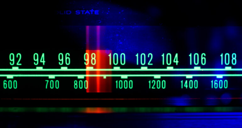 a glowing radio with the marker running through the different stations and frequencies